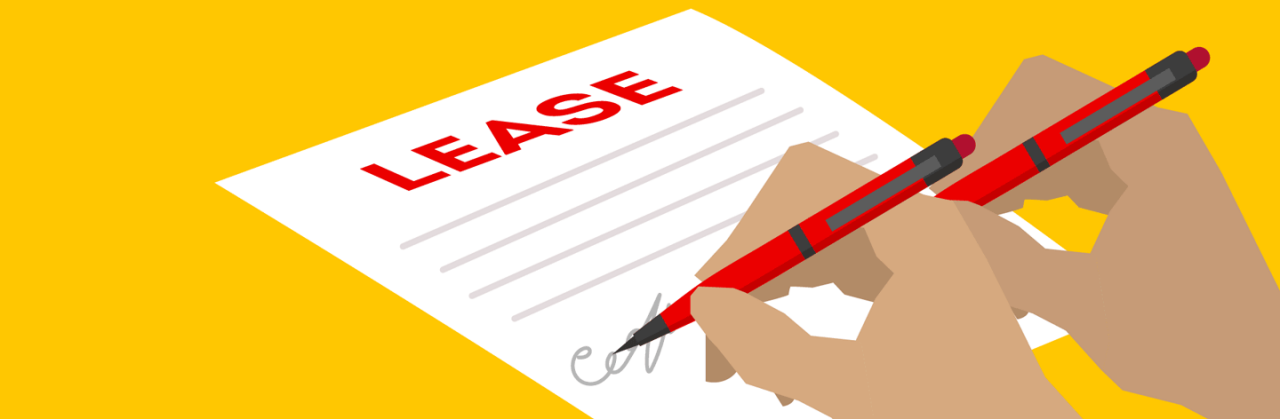 Two people signing a rental property lease with red pens