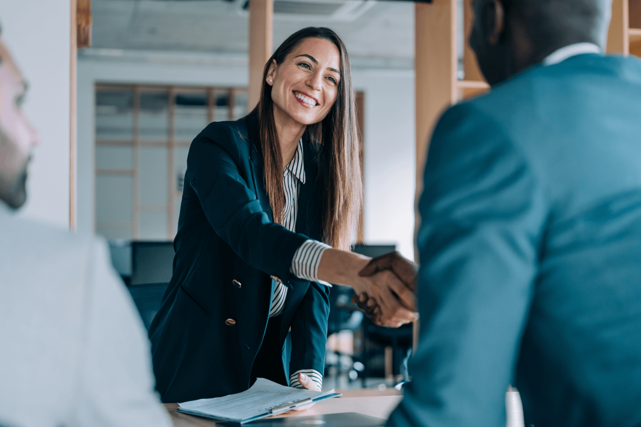 Two people shaking hands to make a deal